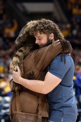 Mikel Hager, incoming Mountaineer mascot, hugs Mary Roush, outgoing Mountaineer mascot.