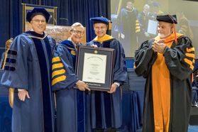 December Commencement speaker Wes Bush receives an HDR from WVU President E Gordon Gee and faculty December 15, 2017.
