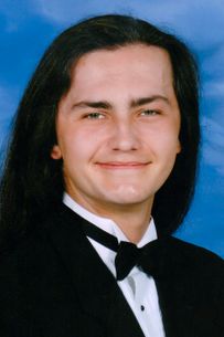 portrait of young man with long black hair
