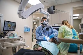 dentist, assistant, examine patient using camera