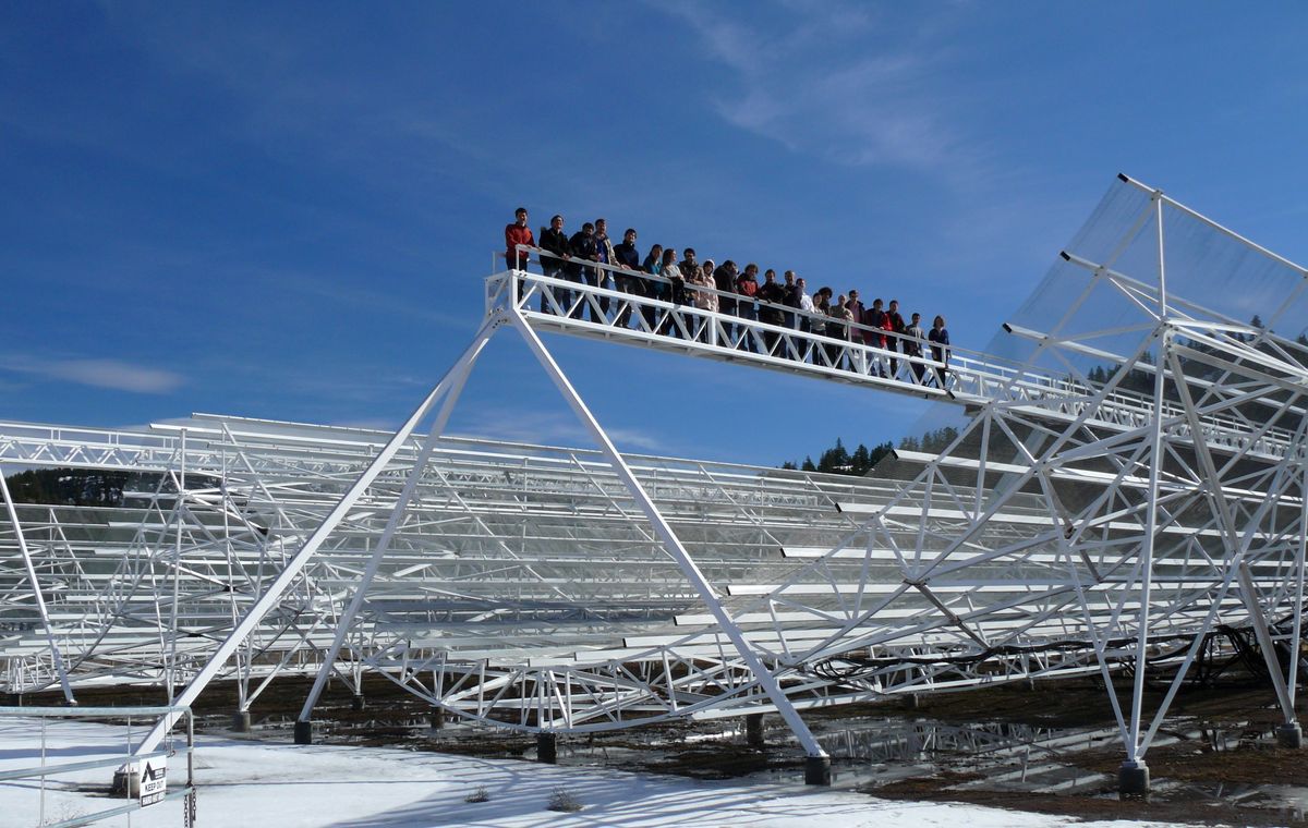A group of people standing on a high platform 