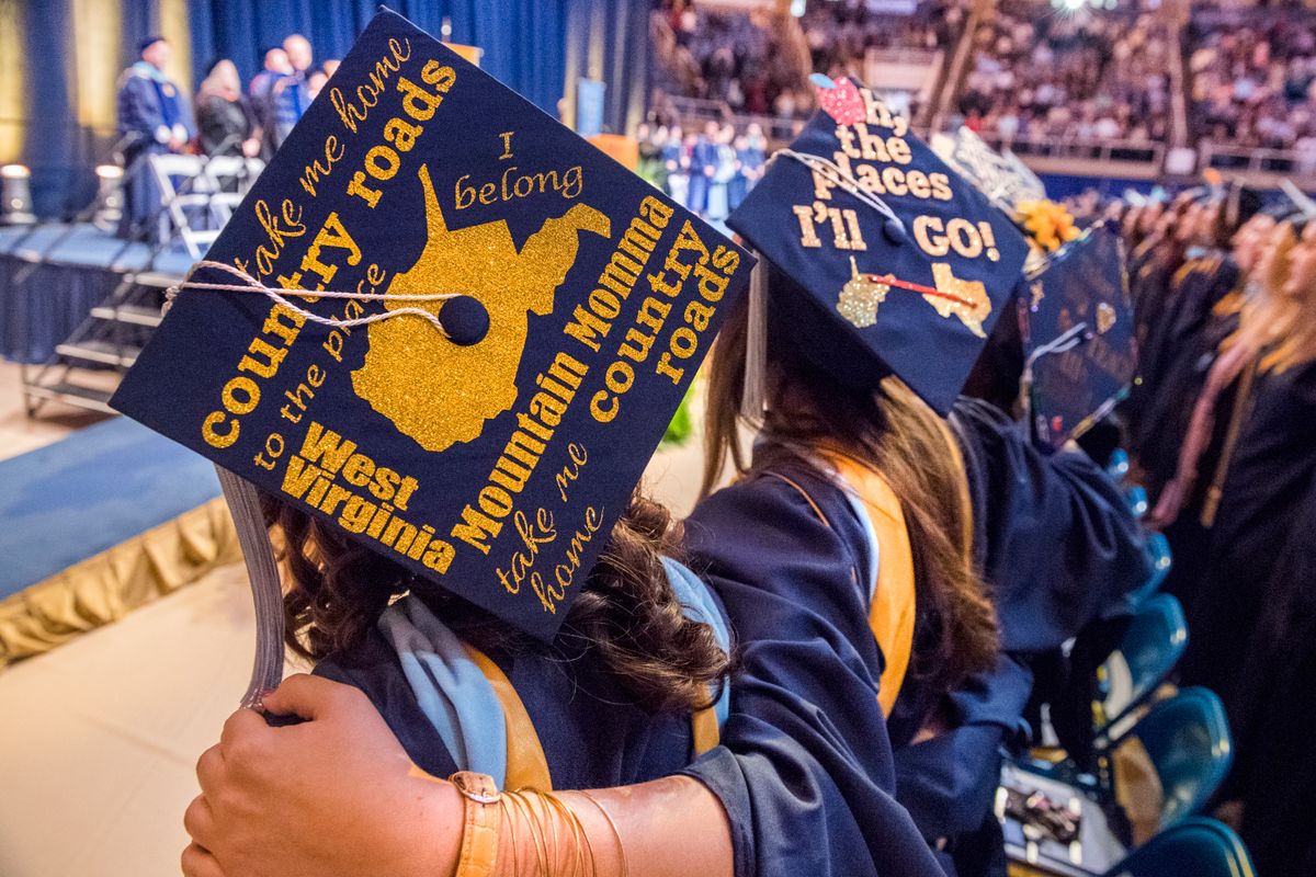 Students stand arm-in-arm during 2016 Commencement ceremony for the College of Education and Human Services