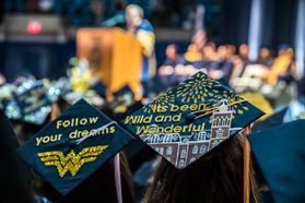Decorated mortarboards at a WVU commencement ceremony