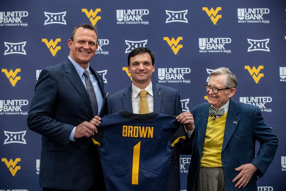 WVU Athletic Director Shane Lyons (L) with new football coach Neal Brown (C) and WVU President Gordon Gee (R)