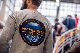 A WVU student wearing a Mountaineer Week shirt.
