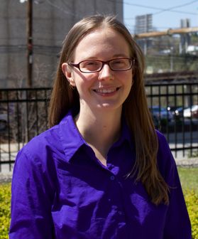 Woman in a purple shirt with glasses