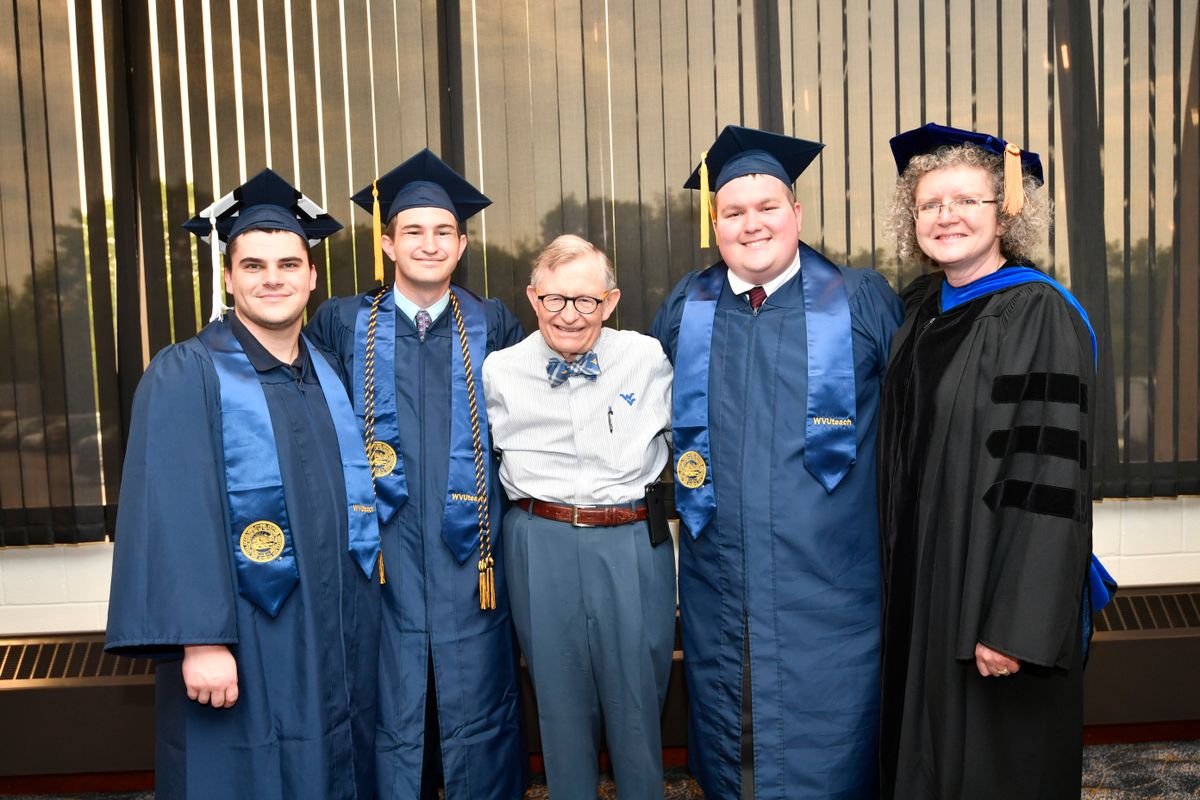 Gordon Gee and Gay Stewart with three WVUteach grads in caps and gowns