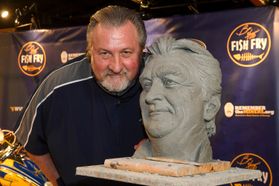 man with beard poses with bust