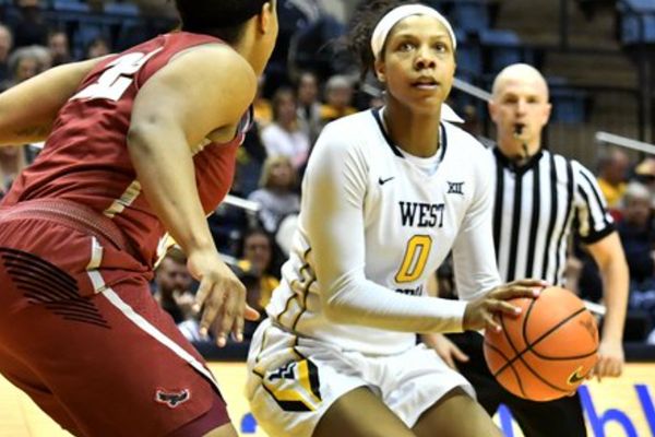 WVU women's basketball player prepares to make a shot with the ball