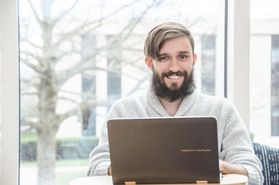 young bearded man with laptop