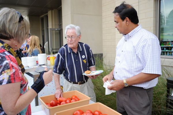 Students, alumni and faculty come together behind the Agricultural Sciences Building on the Evansdale Campus to celebrate the Davis College's and the university's 150th anniversary with a barbecue August 31, 2017. The college also came together to celebrate the naming of the two new tomatoes species created at WVU: West Virginia '17A (Mountaineer Delight) and West Virginia '17B (Mountaineer Pride.)