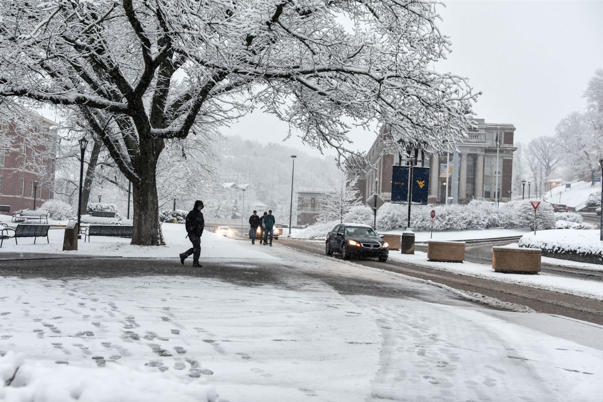 Students walk across a snowy WVU downtown campus.