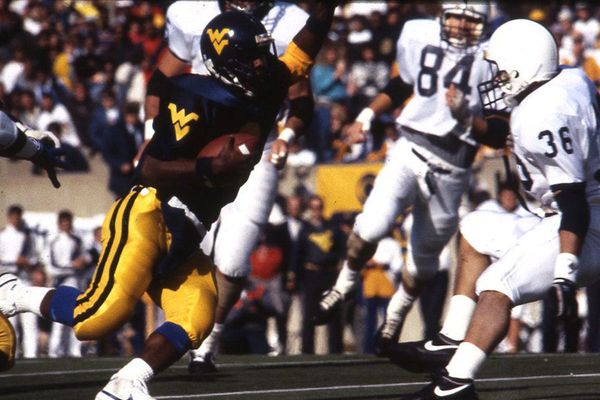 A retro photograph of WVU football players in action.
