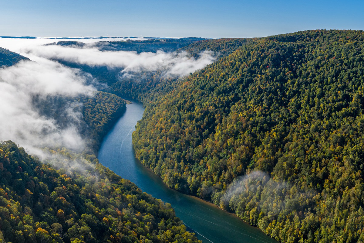 A scenic shot from above of a river cutting through a mountain scape in Appalachia.