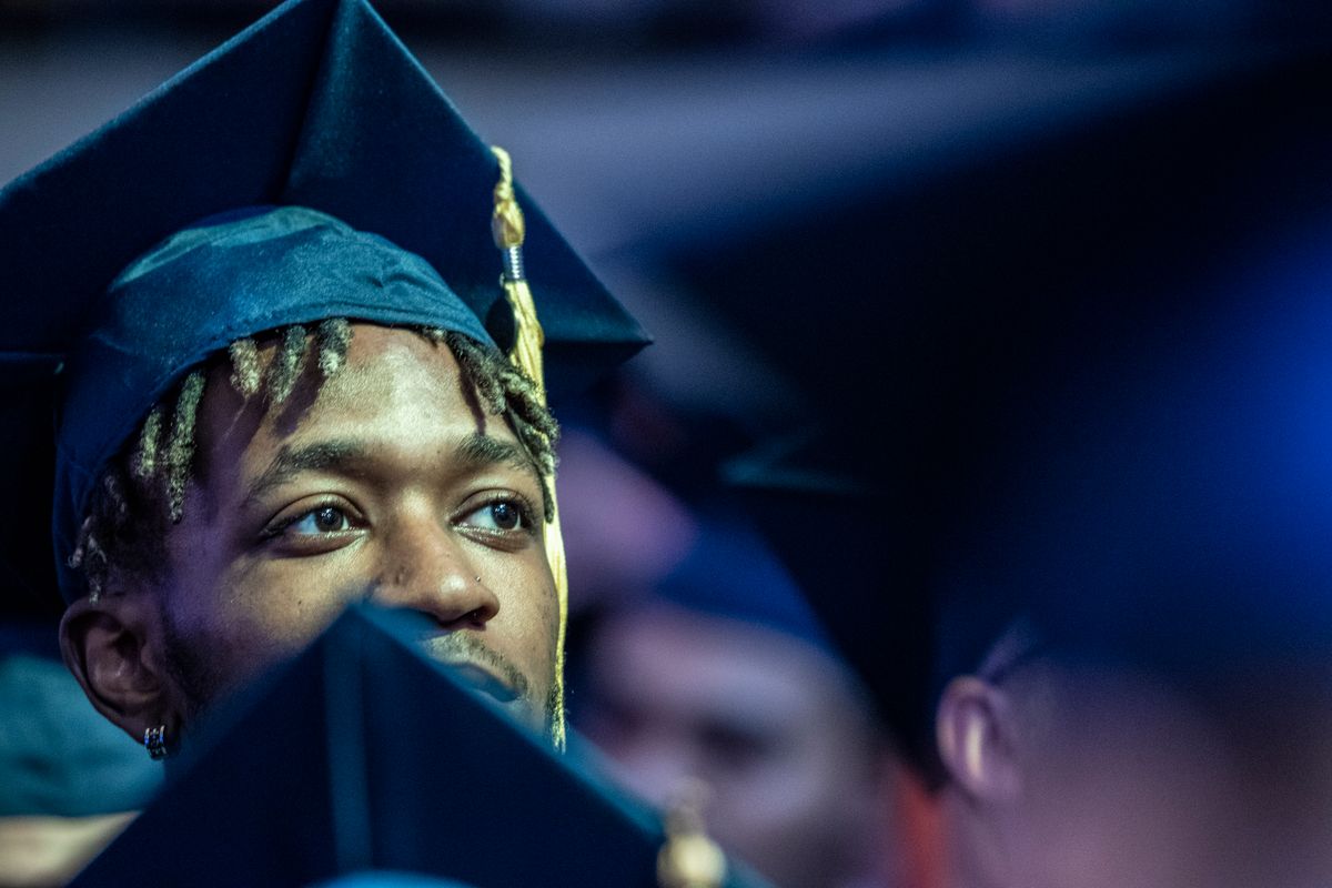 Student attends WVU Commencement in blue cap and gown.