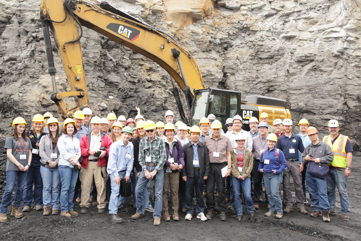 2017 Mine Drainage Symposium gathering in front of a high wall and heavy equipment