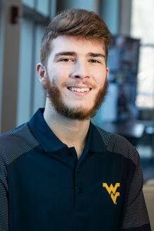smiling man in WVU polo