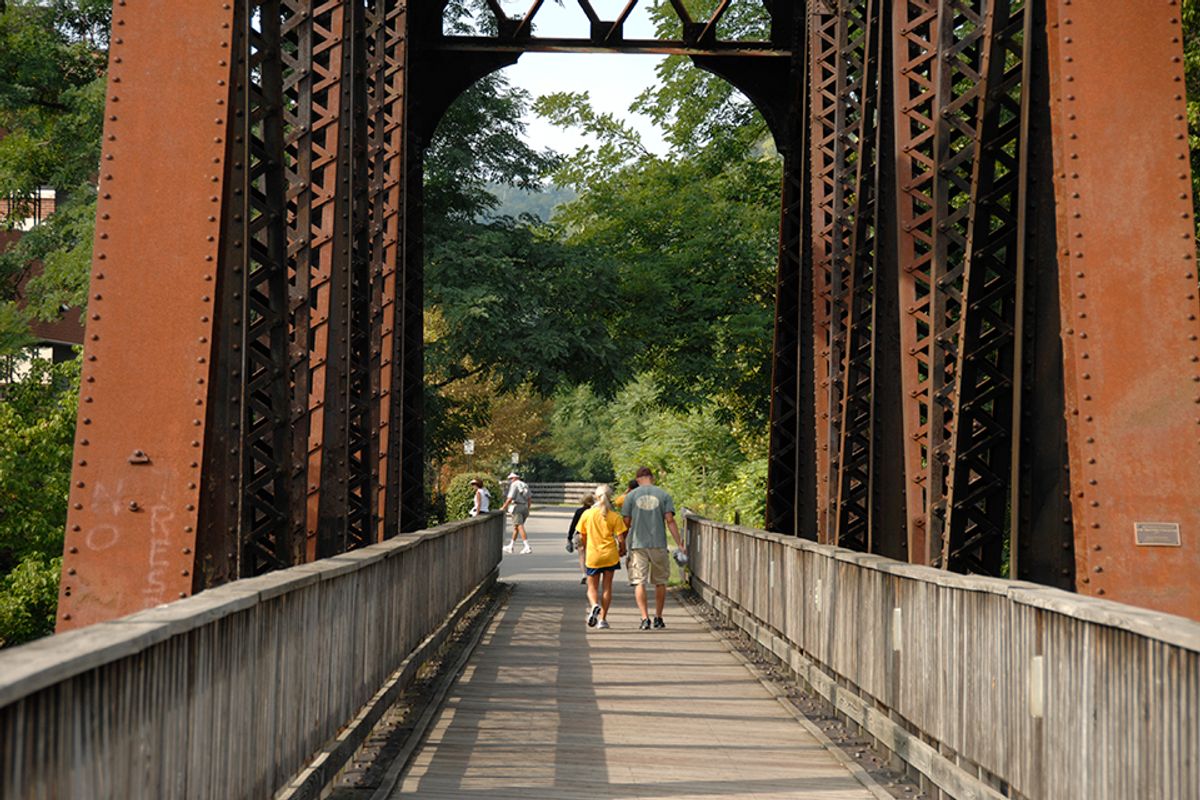 Two people walking on bridge