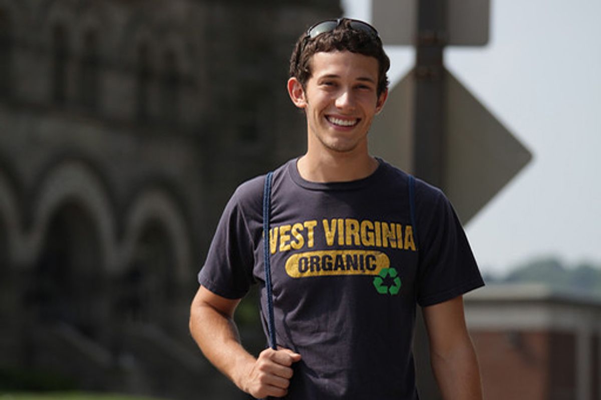 Smiling boy in a WVU shirt.
