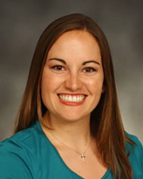 Headshot of WVU Medicine doctor Dr. Gretchen Garofoli. She is pictured in front of a beige background and is wearing a teal colored top. She has long, auburn colored hair. 