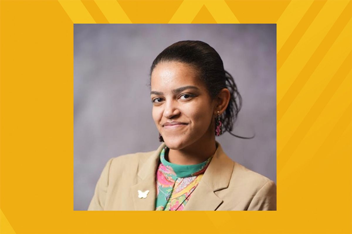 Headshot of WVU School of Pharmacy student Yohanna Berhanu. She is wearing a tan jacket over a multi-colored blouse with her brown hair pulled back. 