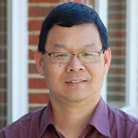 Headshot of WVU researcher Hailin Li. He is standing outside in front of a brick wall wearing a maroon shirt and glasses. He has short black hair. 