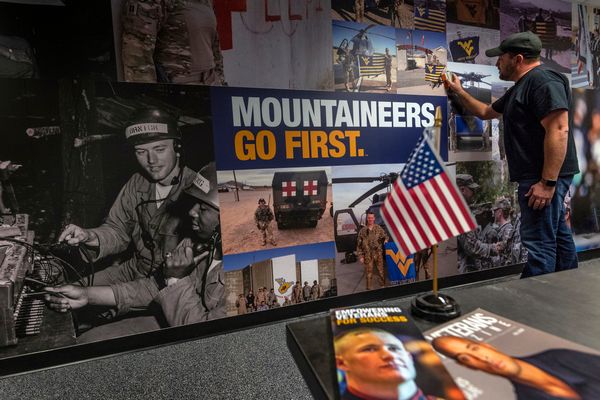 Jani Horvath wraps the wall of the WVU Veteran and Military Family Support Headquarters with military lifestyle scenes.