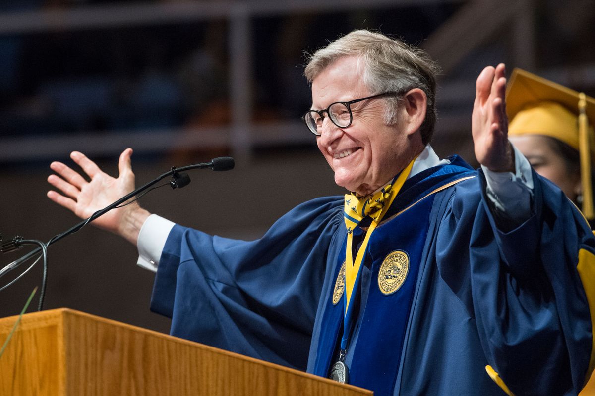 Gordon Gee standing at a podium with his arms open wide.