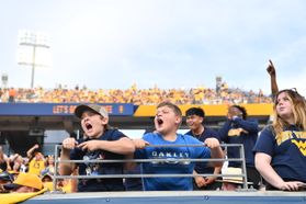 Two young boys cheer on the Mountaineer football team from the stands during last year's homecoming game. 
