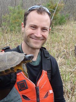 smiling man holding turtle