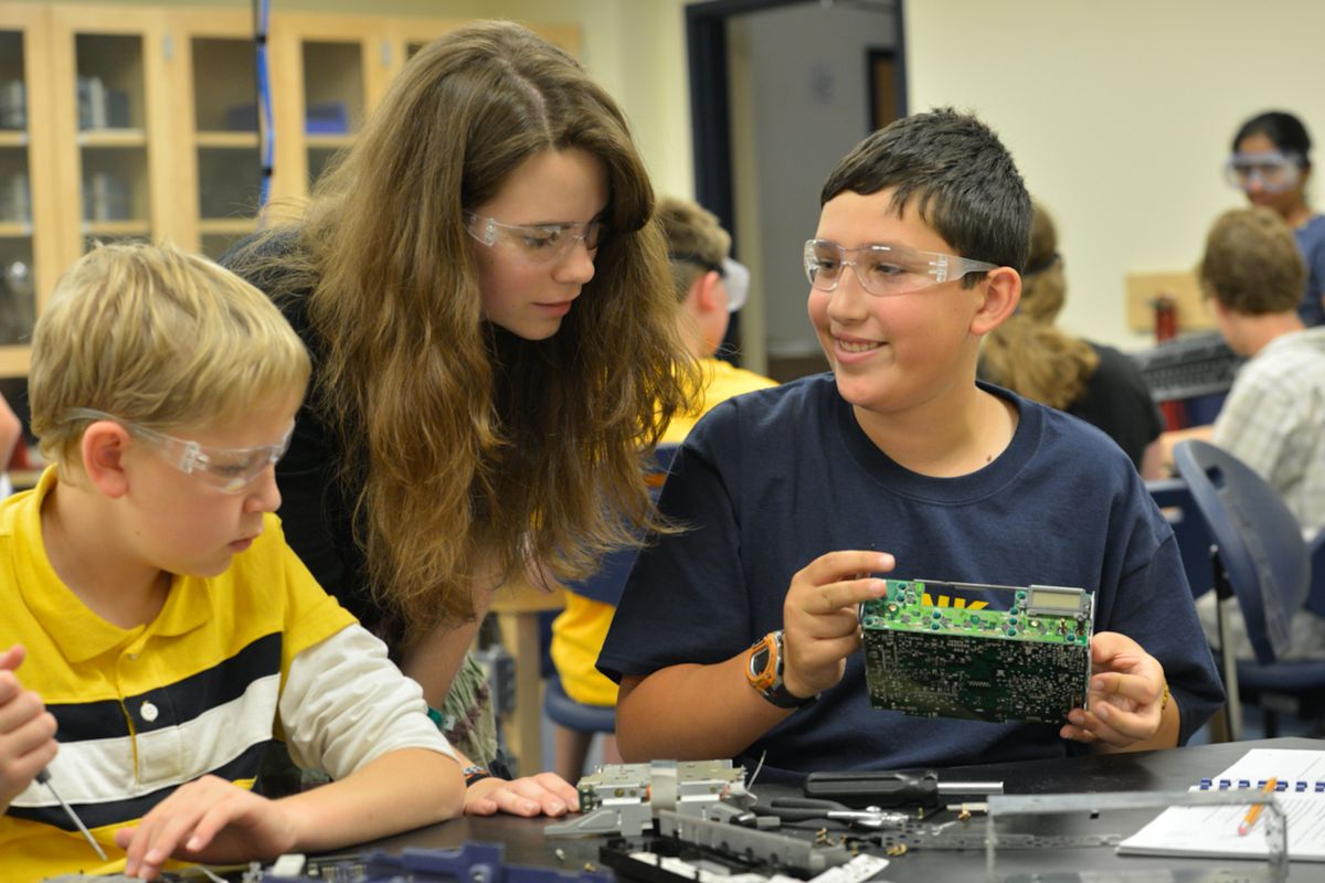 Instructor oversees students participating in STEM camp activities