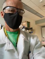 man in lab coat and mask