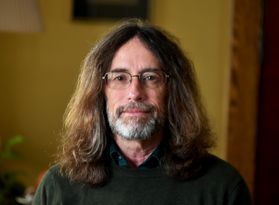 man with long hair, beard, glasses