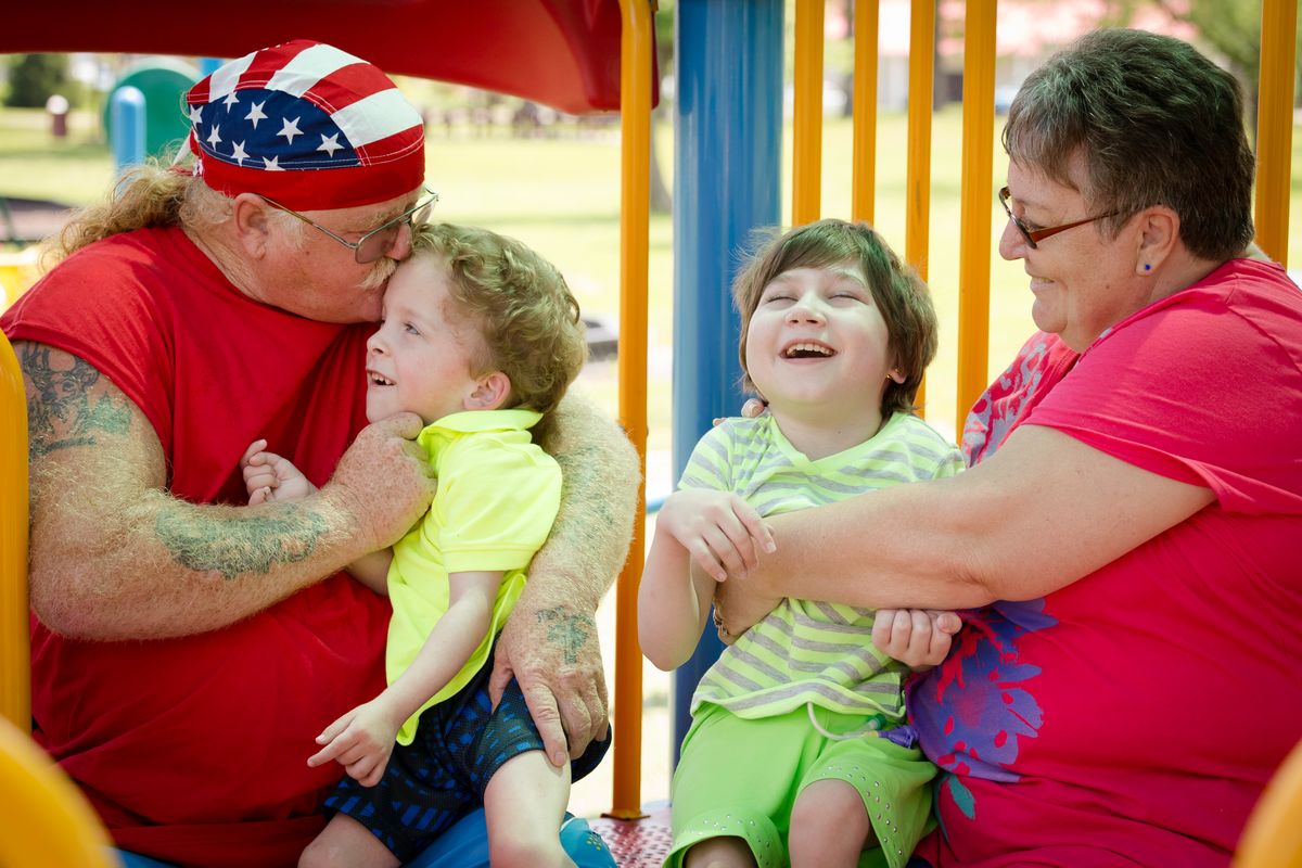 An image showing two foster parents with their special needs foster children. The 