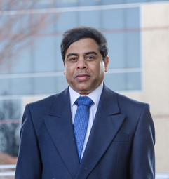 Headshot of WVU professor Debansu Bhattacharyya wearing a blue suit and tie with a white dress shirt. Bhattacharyya is of Indian decent. 