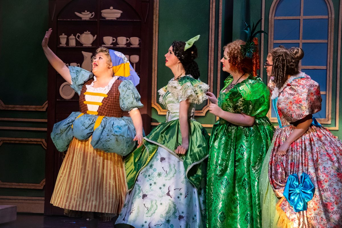A group of female actresses perform Cinderella in brightly colored costumes. 