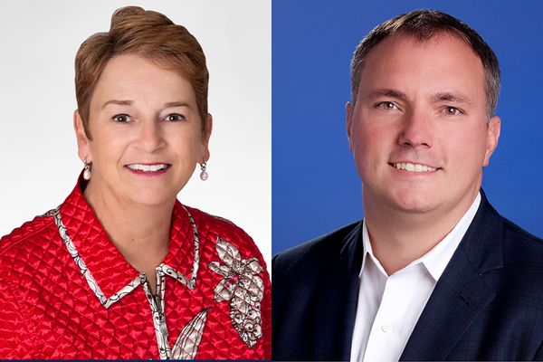 Two headshots side by side. The headshot on the left is of Dr. Jo Ann Shaw. She is pictured against a white background and is wearing a red jacket with white details. She has short red hair. The photo on the right is Travis Rosiek on a blue background. 