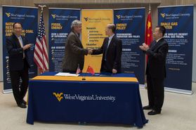 WVU Vice President for Research Fred King shakes hands with Cao Yang, chairman and CEO of Shanxi International Energy Group Company, Ltd., at a signing ceremony for expanded cooperation in clean energy research, training and education. 