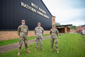 national guard members stand in front of a brick building